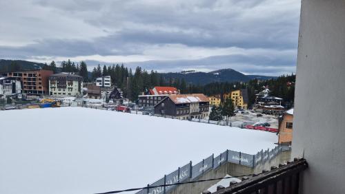 a view of a city with a snow covered roof at VilaBellavistasmjestaj in Vlasic