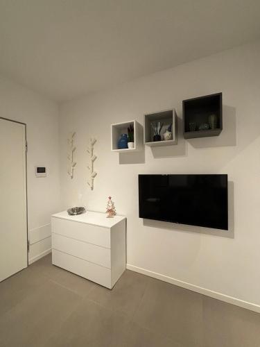 a living room with a flat screen tv on a wall at SUITE NAVIGLIO 26 in Parma
