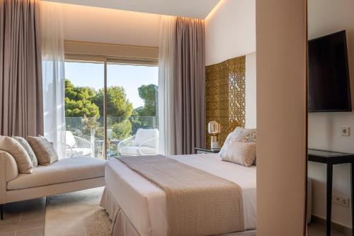 a hotel room with a bed and a balcony at Dionis Boutique Hotel & Spa in Jávea