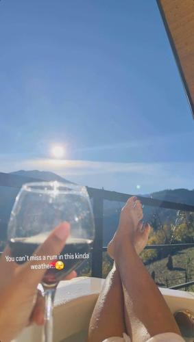 a woman laying in a bath tub with her feet up at Eco cottage sunrise merisi in Merisi