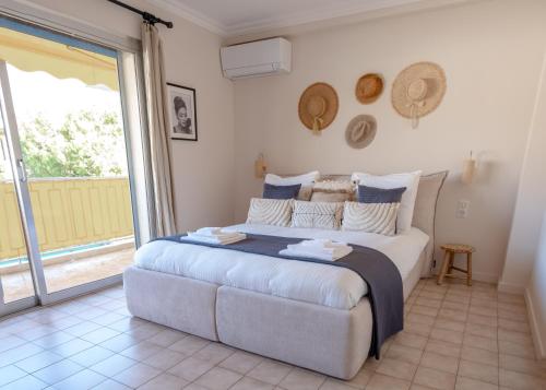 a bedroom with a large bed and a large window at 3 pièces au cœur du cros de cagnes in Cagnes-sur-Mer