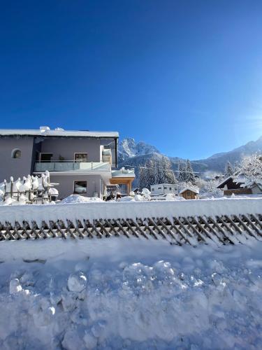 a house with snow on the ground in front of it at Appartement Wanneck in Biberwier