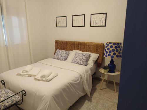 a bedroom with a bed with towels on it at Casa Rural Tazgona in Antequera