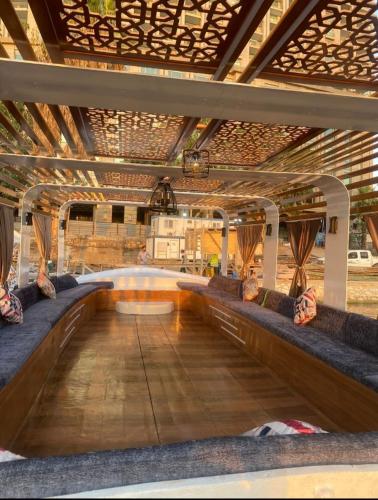 a swimming pool in a room with couches at Nile Boat in Cairo