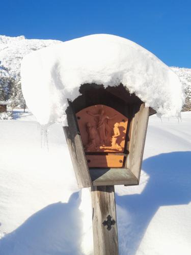 a snow covered bird house in the snow at Haus Hotz Apart Talblick in Grins