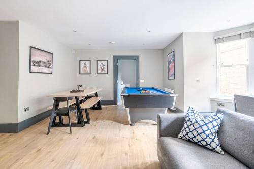 a living room with a pool table and a couch at Immaculate 3 Bed Apartment with Private Entrance in Inverleith in Edinburgh
