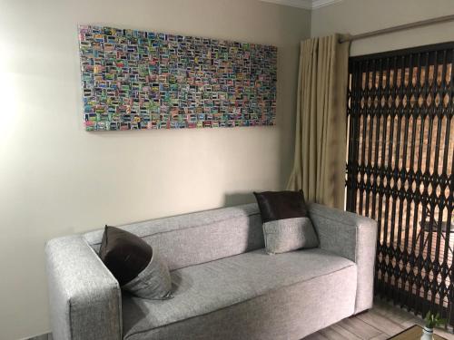 a living room with a couch and a painting on the wall at Forest Hill Wilderness in Wilderness