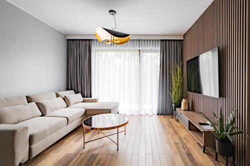 a living room with a couch and a table at StoneHill24 - Apartament & Spa in Szklarska Poręba