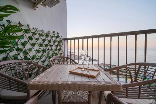 una mesa de madera con un bolso en la parte superior de un balcón en Charming Seaview Condo in Saba Pasha, en Alejandría