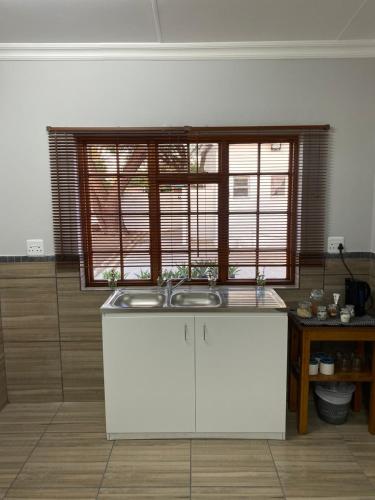 a kitchen with a sink and a large window at The Old Fort in Aberdeen