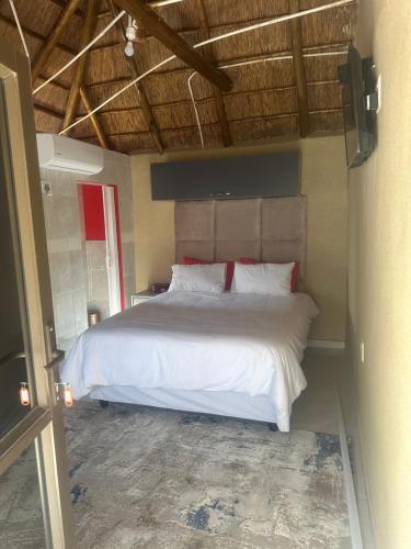 a bedroom with a large white bed in a room at Sweet Nice Guest House in Ga-Rankuwa