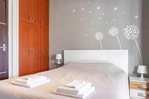 a bedroom with a bed with two towels on it at The Owl - Stylish Penthouse - Gazi 1BDRM in Athens