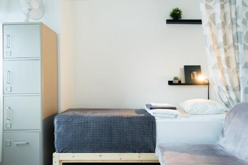 a small bedroom with a bed and a chair at Inn Tourist Hostel in Helsinki
