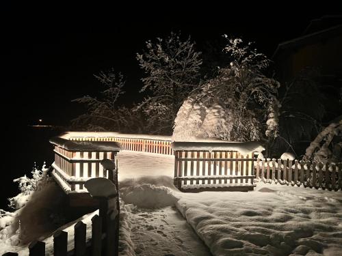 a fence covered in snow at night at Haus Central Lofer in Lofer