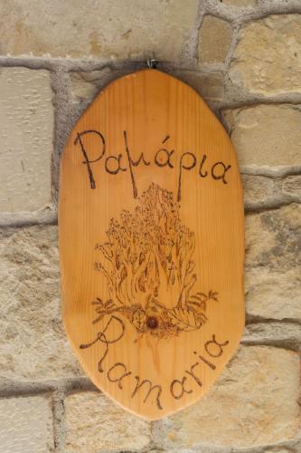 a wooden sign on a brick wall at Τα Πέτρινα της Ελάτης - Petrina Elatis in Elati Trikalon
