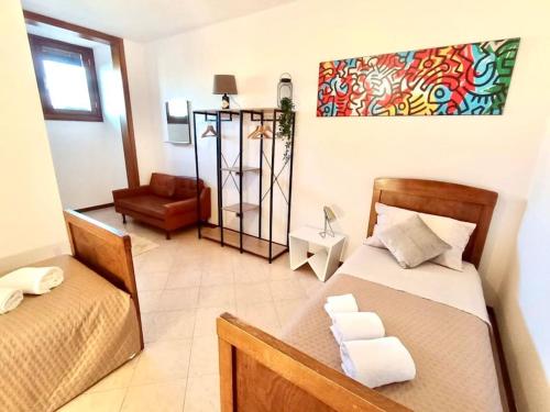 a room with two beds and a chair in it at Relax nelle colline del Prosecco in Pederobba
