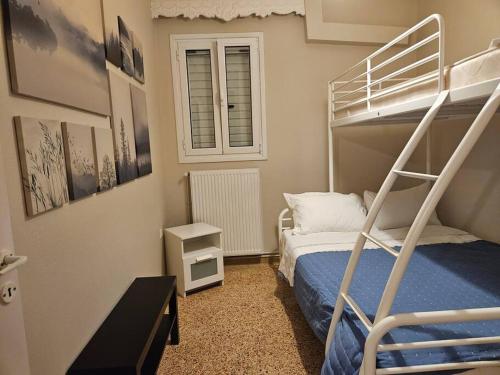 a bedroom with a bunk bed with a ladder at Tilfousa's Home in Ipsilándis