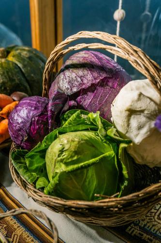 a basket of lettuce and other vegetables on a table at Stardome Spiritual Experience in Ollantaytambo