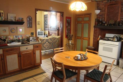 a kitchen with a wooden table and a table and chairs at New York Homestay in Newark