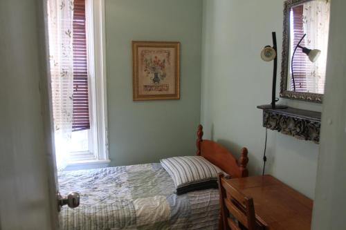 a bedroom with a bed and a picture on the wall at New York Homestay in Newark