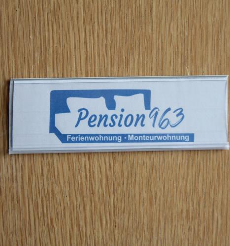 a sign on a wooden wall that says permission at Pension963 in Crimmitschau