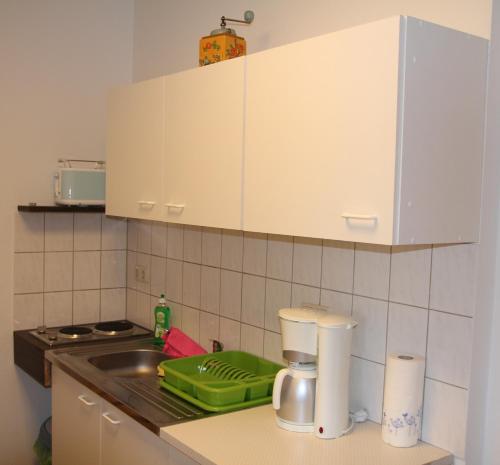 a kitchen with a sink and a counter top at Pension963 in Crimmitschau