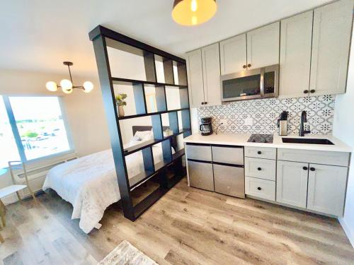 a kitchen with a bed and a sink in a room at The Rivet Apartments in Reno
