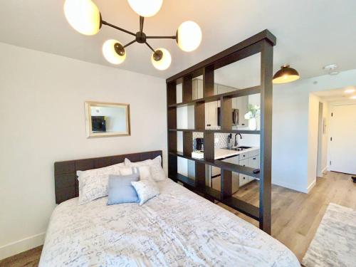 a bedroom with a large bed with a large mirror at The Rivet Apartments in Reno