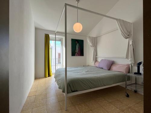 1 dormitorio con cama con dosel en una habitación en Design & art, patio with orange tree, near Seville, en Carrión de los Céspedes