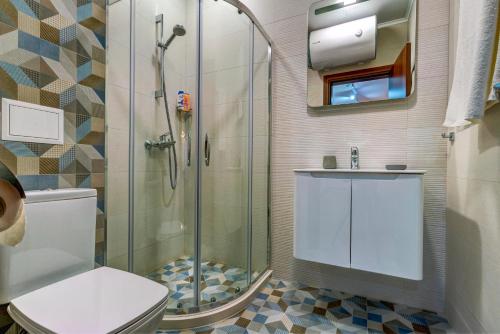 a bathroom with a shower and a toilet and a sink at N.Joy Holiday Apartment 532 by Oak Residence in Smolyan