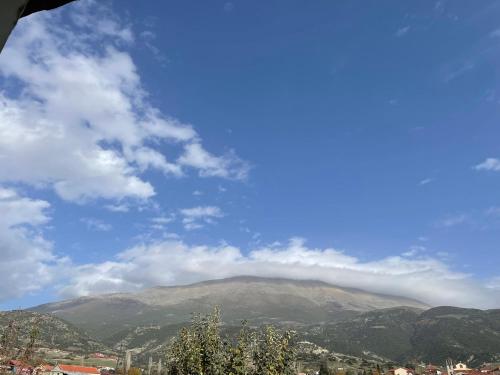 a view of a mountain with clouds in the sky at Villa Olympus in Kalývia