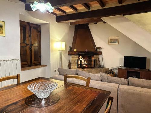 a living room with a table and a couch at Casa Renata in Arcidosso