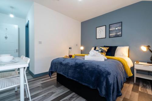 a bedroom with a bed and a desk and a bed at Sky Rooms One Bedroom Modern Studio Apartment 6 in Birmingham