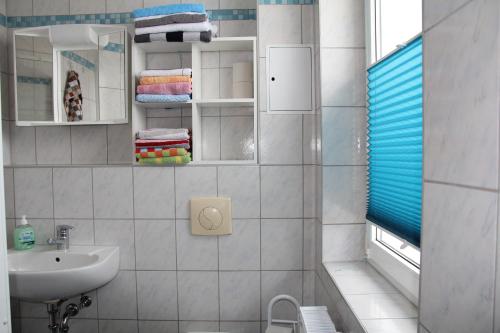 a white bathroom with a sink and a mirror at Pension963 in Crimmitschau