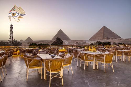 a restaurant with a view of the pyramids at Shadow Pyramids Suites and Jacuzzi in Cairo