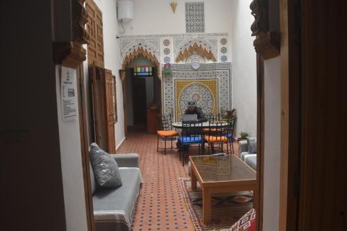 a living room with a table and chairs at Hostel Capital in Rabat