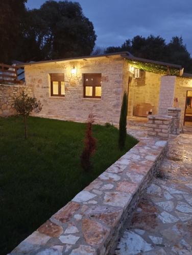 a house with a stone walkway in front of it at Ekali stone house in Kaléntzion
