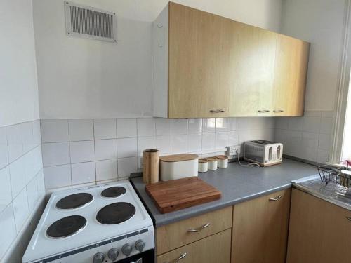 a kitchen with a stove and a counter top at One/Two Bedroom Apartment Close to Sea & Centre in Hastings