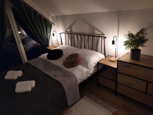 a bedroom with a bed with two pillows on it at Górska Stodoła in Lipowa