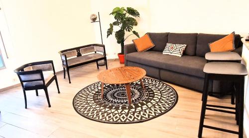 a living room with a couch and chairs at SANXENXO , apartamento nuevo 300 mts playa Silgar in Sanxenxo