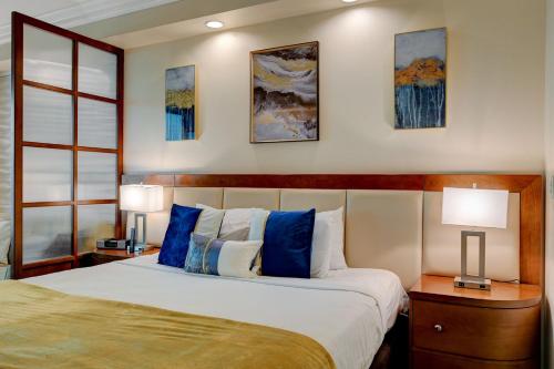 a bedroom with a large bed with blue pillows at Sin City Suite @ MGM Signature in Las Vegas