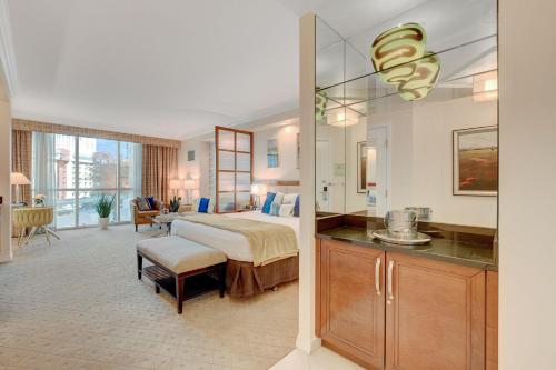 a bedroom with a bed and a desk in a room at Sin City Suite @ MGM Signature in Las Vegas