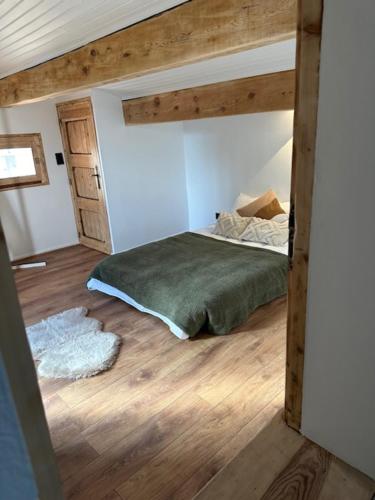 a bedroom with a bed in a room with wooden floors at Les 100 Ciels Font-Romeu in Font Romeu Odeillo Via