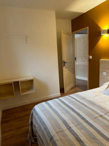 a bedroom with a bed and an open door at Les 100 Ciels Font-Romeu in Font Romeu Odeillo Via