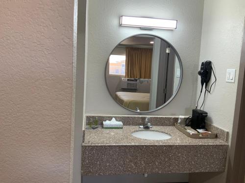 a bathroom with a sink and a mirror at Value Lodge in Alpine