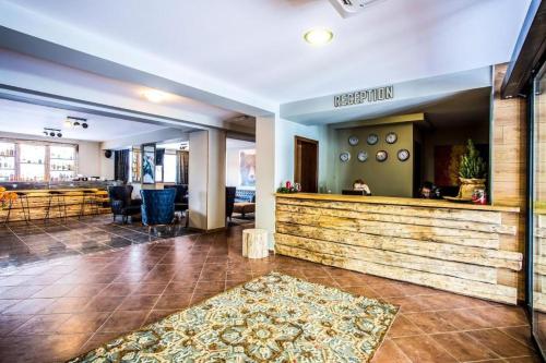 a lobby with a bar and a restaurant at N.Joy Holiday Apartment 417 by Sunny Hills in Pamporovo