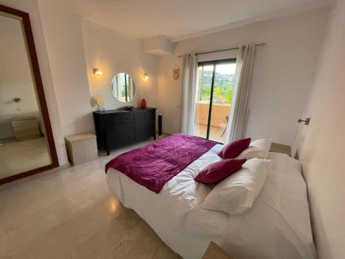 a bedroom with a large bed and a mirror at La Almadraba 412 in Manilva