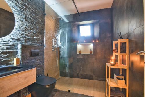 a bathroom with a sink and a glass shower at Villa Naya et sa Piscine chauffée sans vis-à-vis in Agadir