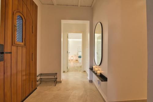 a hallway with a mirror and a table with candles at Villa Naya et sa Piscine chauffée sans vis-à-vis in Agadir