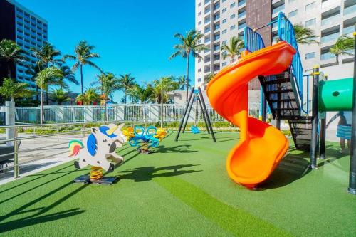 a park with a playground with a slide at Salinas Exclusive Resort in Salinópolis